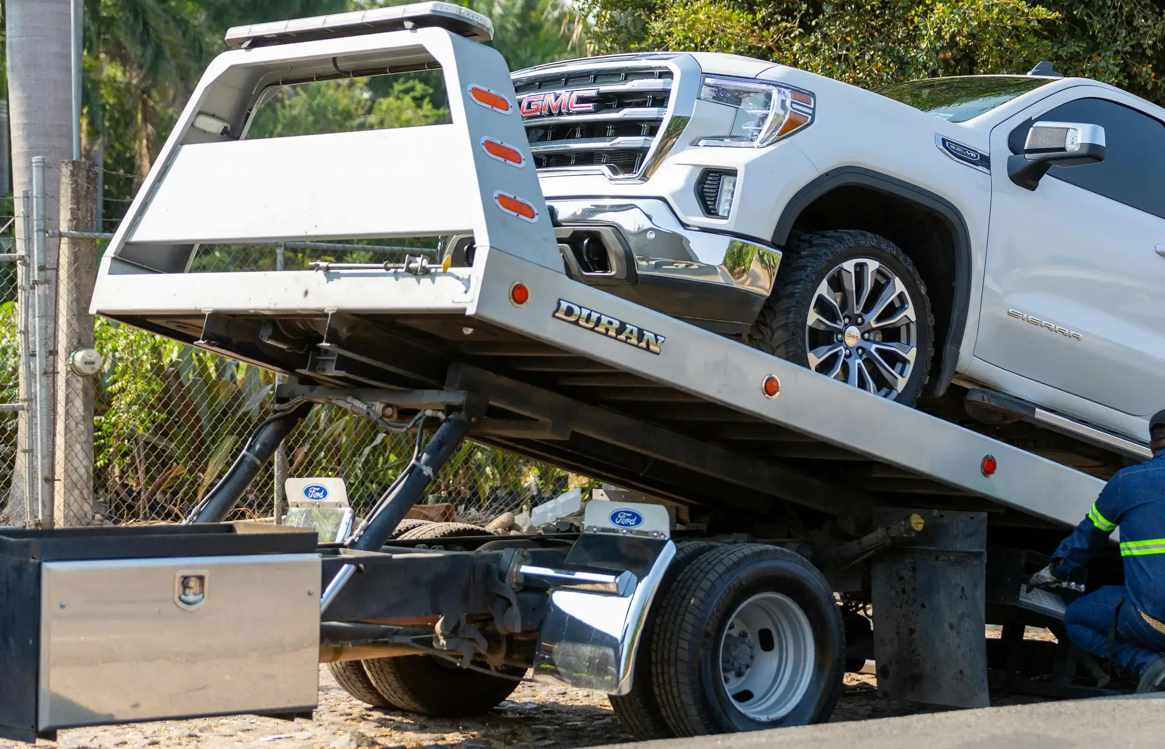 White truck being winched onto tow truck