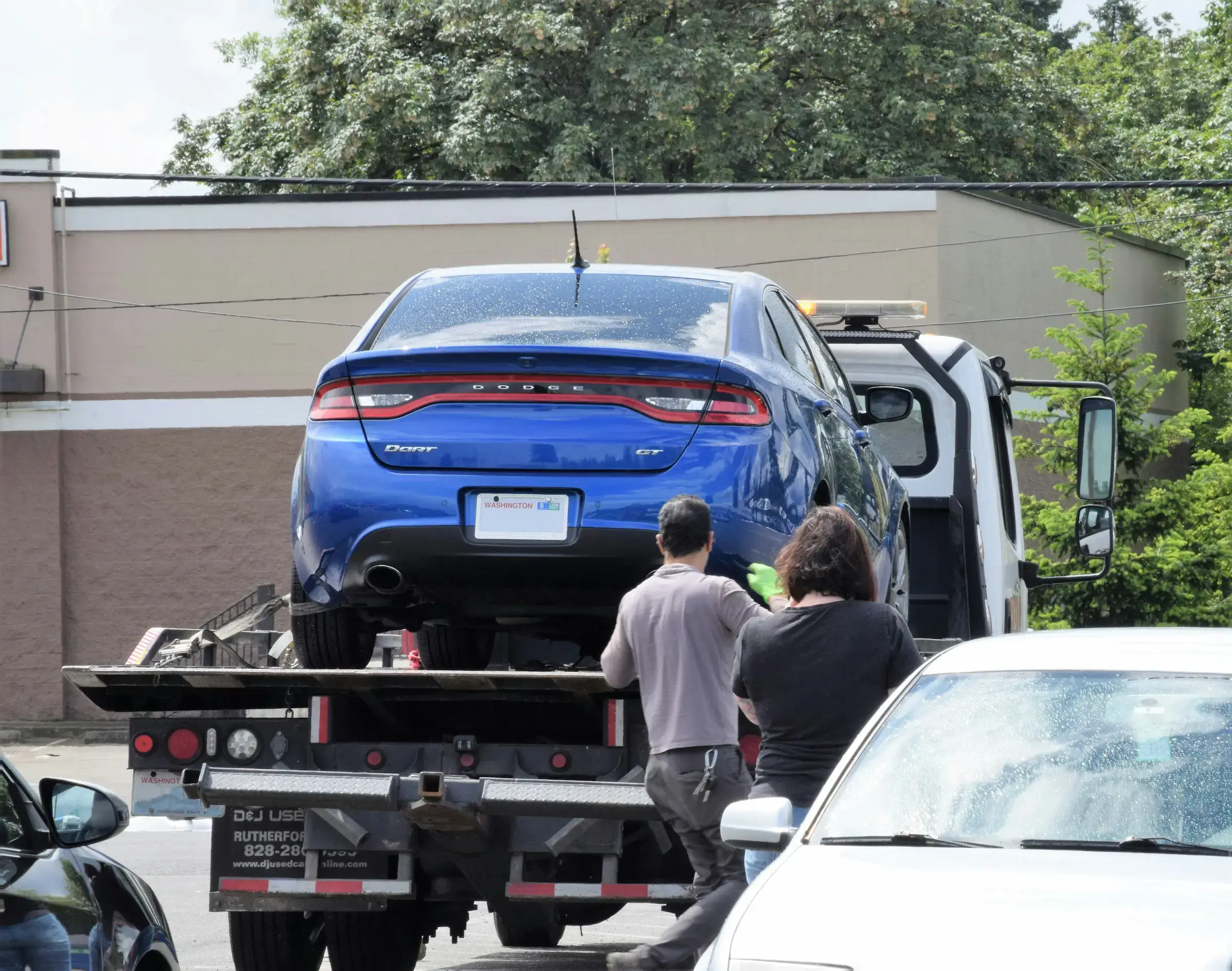 A photo of a tow truck with a car on it