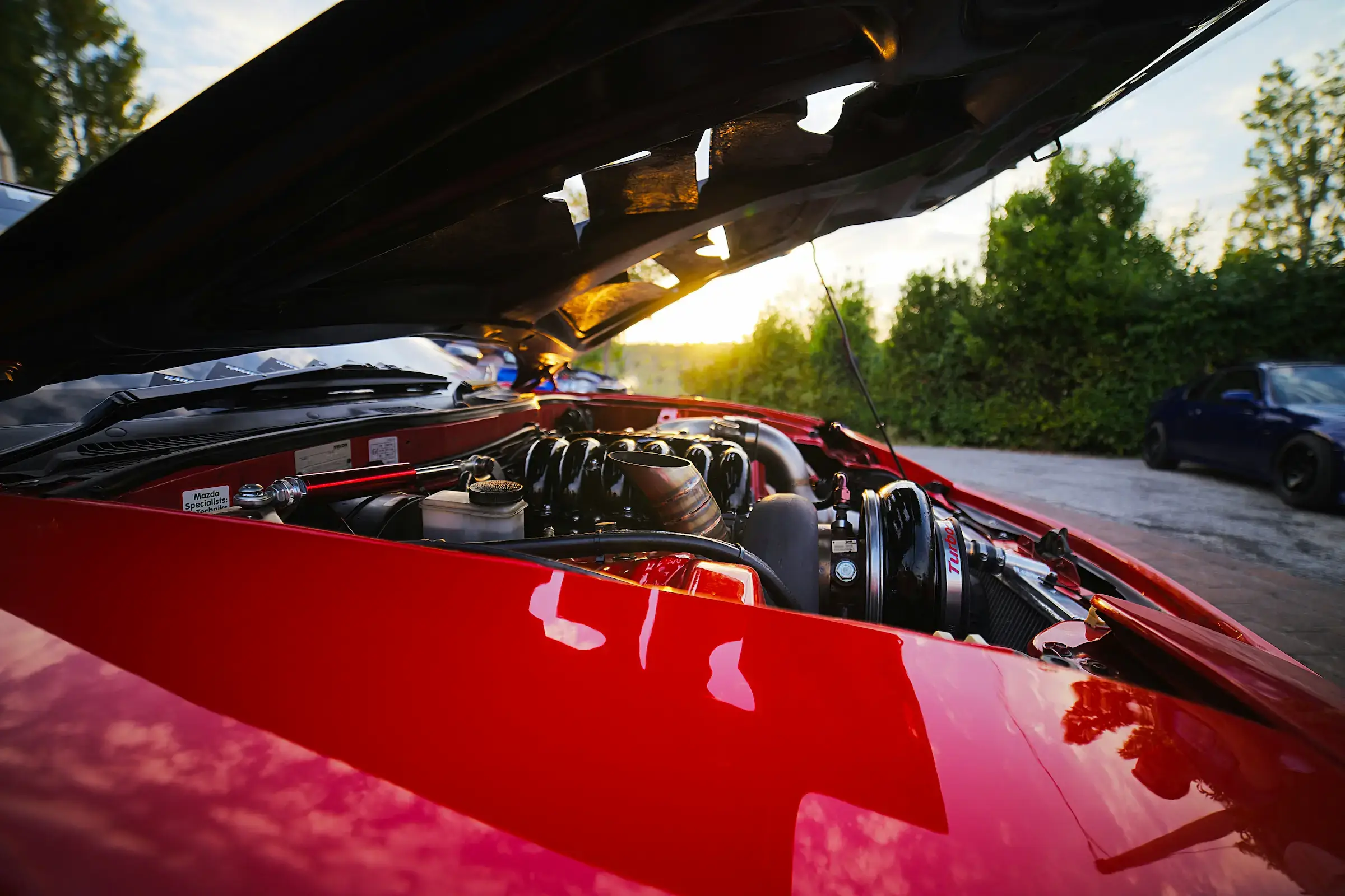 Car with hood up for roadside assistance